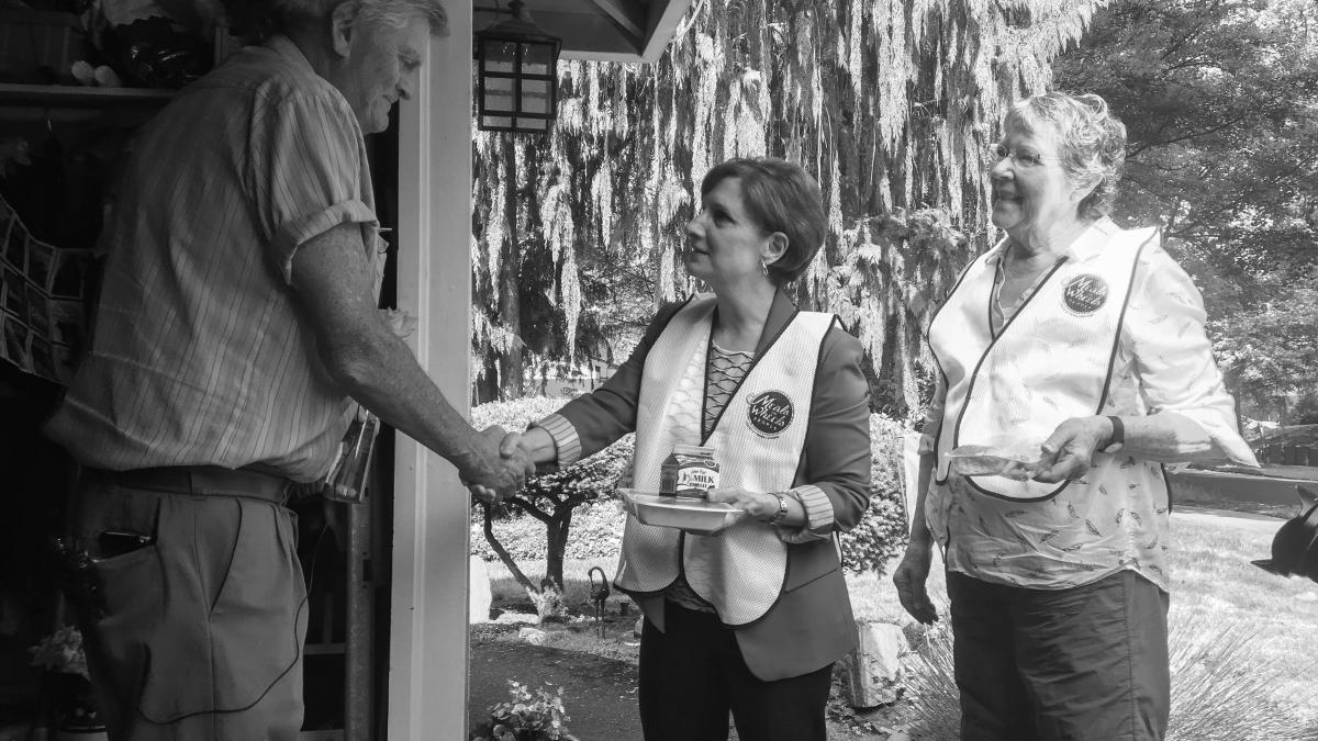 Rep. Bonamici shaking the hand of a senior citizen