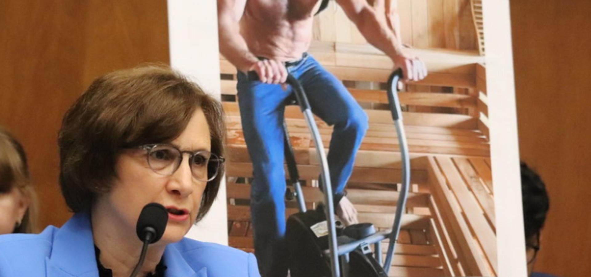 Congresswoman Bonamici questions RFK Jr. at the dais, with a poster of the MAHA Kid Rock video behind her