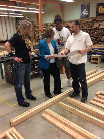 Bonamici standing in woodworking shop